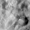 PIA15548: Spots of Dark Material Surrounding an Impact Crater